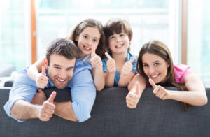 Family At Home With Thumbs Up